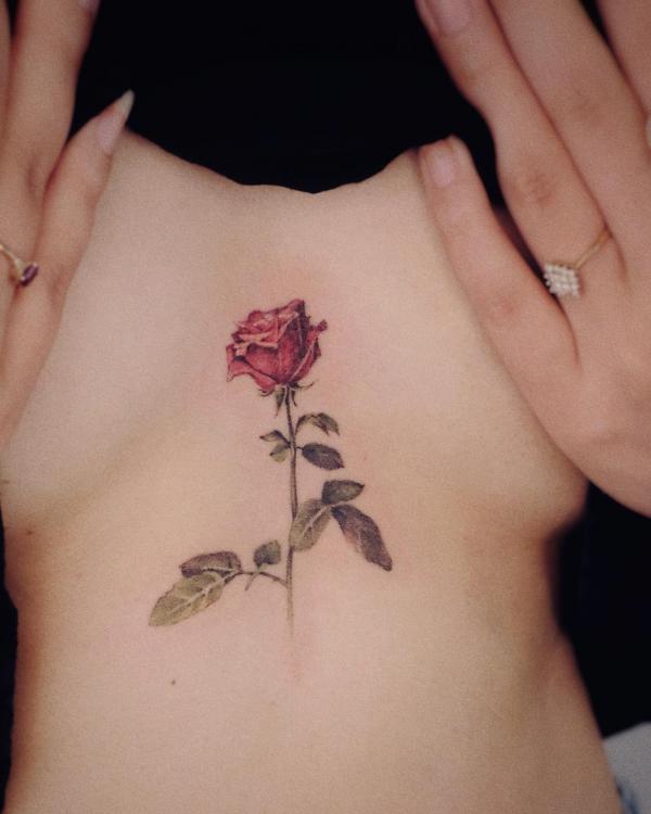 Rose with stem sternum tattoo
