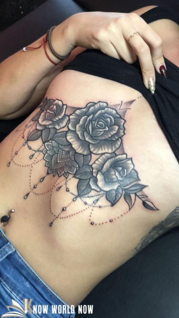 Roses and mandala lotus with pendant sternum tattoo black and grey