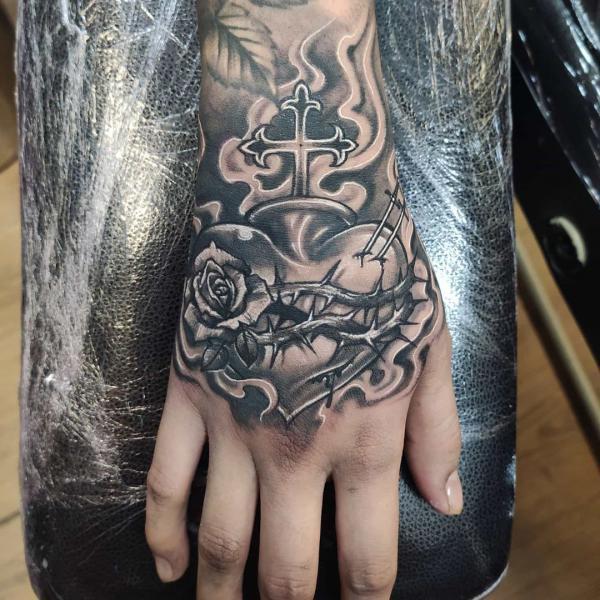 Sacred Heart of thorns hand tattoo