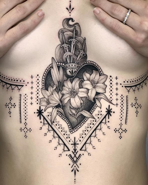 Sacred heart with daggers lilies and pendant sternum tattoo