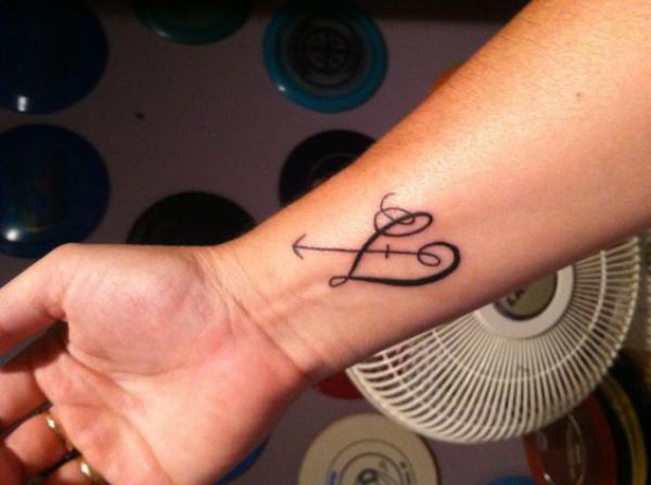 Sagittarius and heart tattoo on wrist