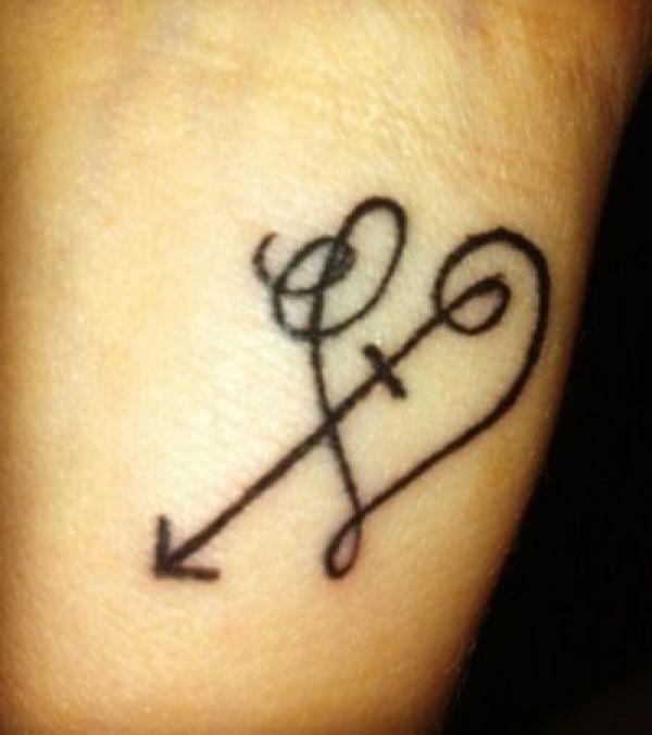 Sagittarius arrow with heart tattoo