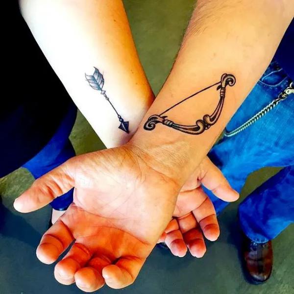 Sagittarius bow and arrow matching tattoo on wrist