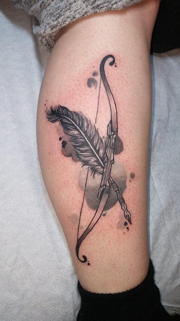 Sagittarius bow and feather arrow lower leg tattoo