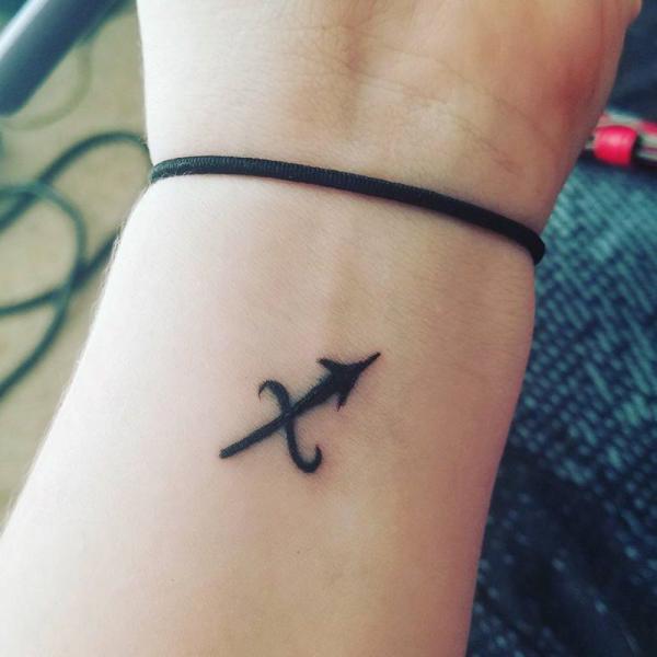 Sagittarius glyph wrist tattoo