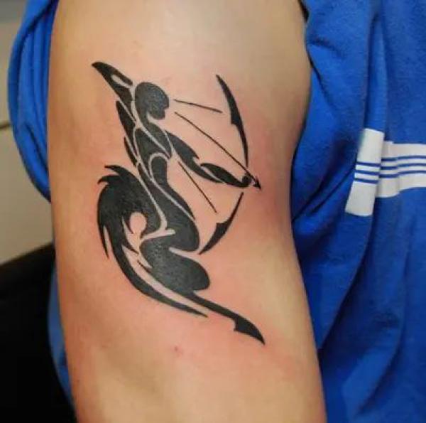 Sagittarius tribal upper arm tattoo
