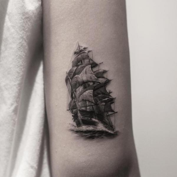 Sailing boat back of arm tattoo