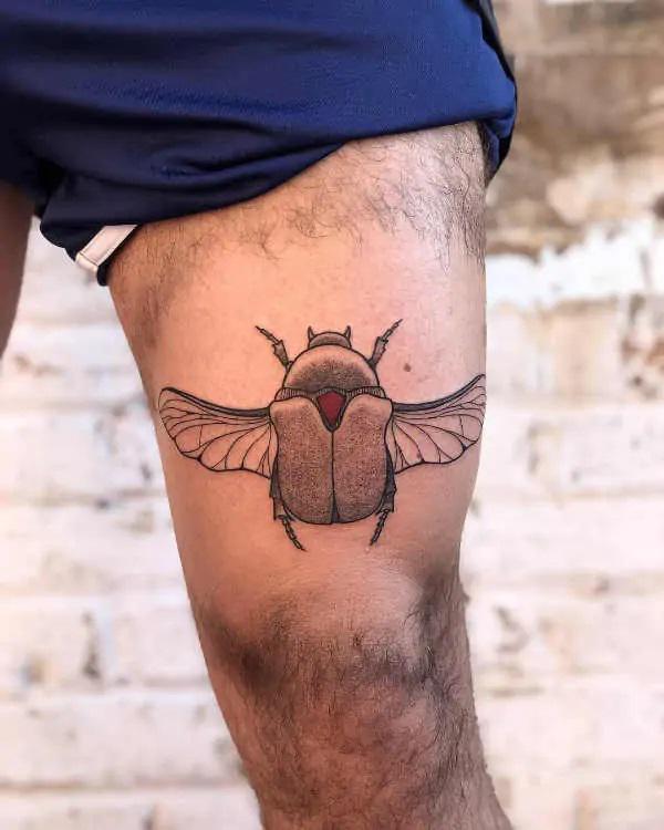 Scarab Beetle tattoo above knee