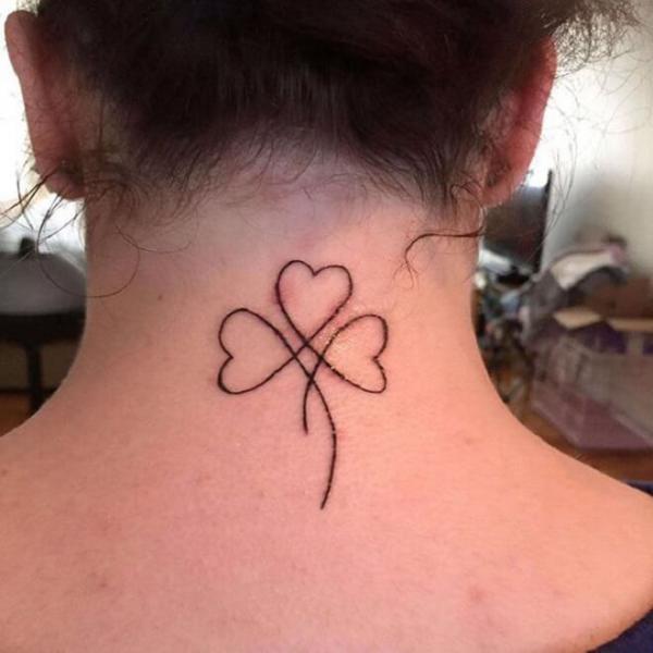 Shamrock outline tattoo on the back of neck