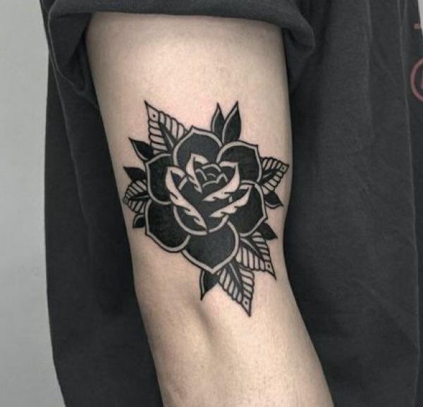 Side elbow black rose tattoo traditional
