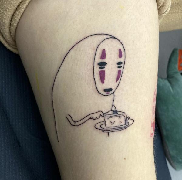 Simple No Face upper arm tattoo