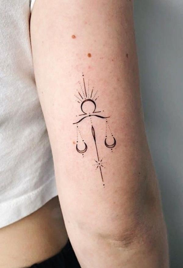 Simple libra back of arm tattoo