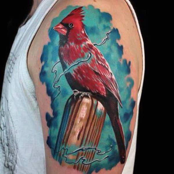 Single cardinal on blue watercolor backdrop tattoo