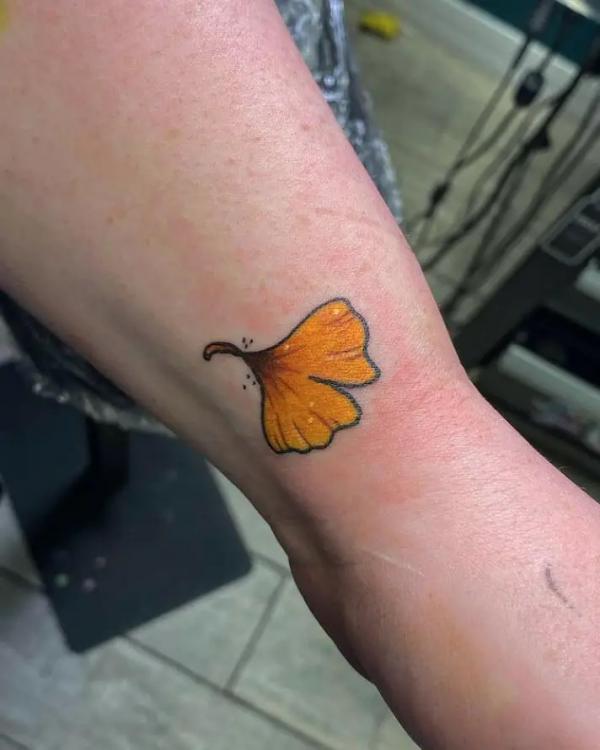 Single yellow ginkgo leaf tattoo