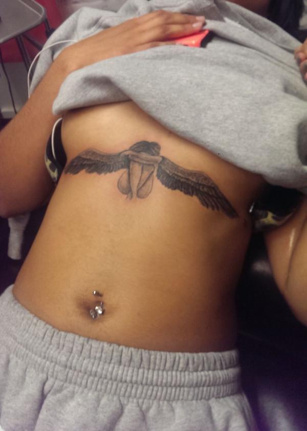 Sitting angel sternum tattoo