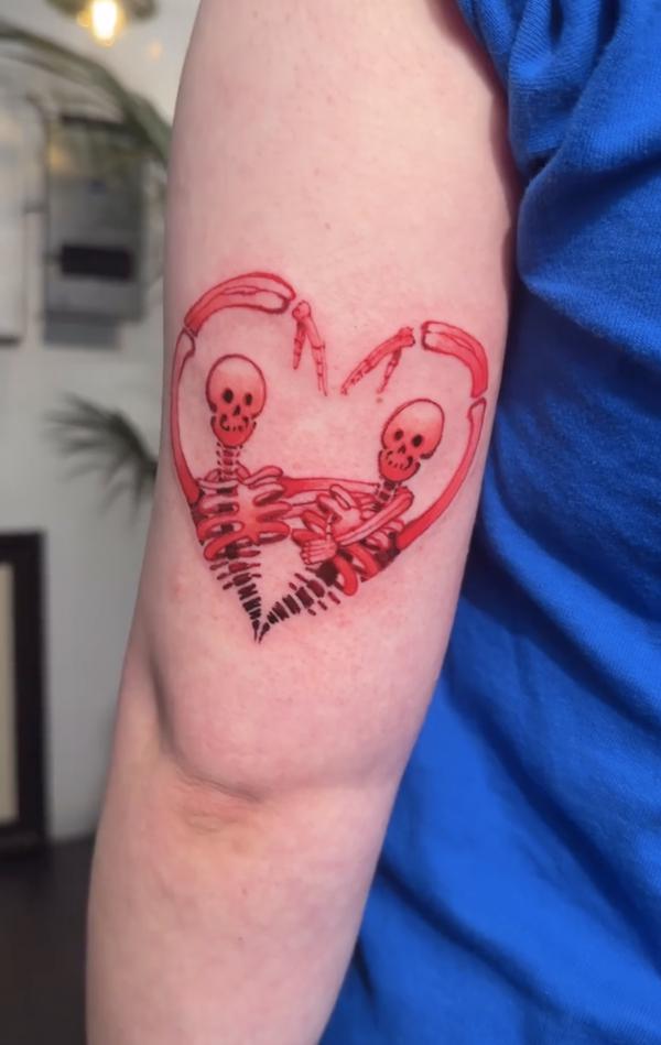 Skeleton lover back of arm tattoo