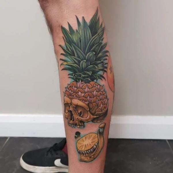 Sliced Pineapple Skull leg tattoo