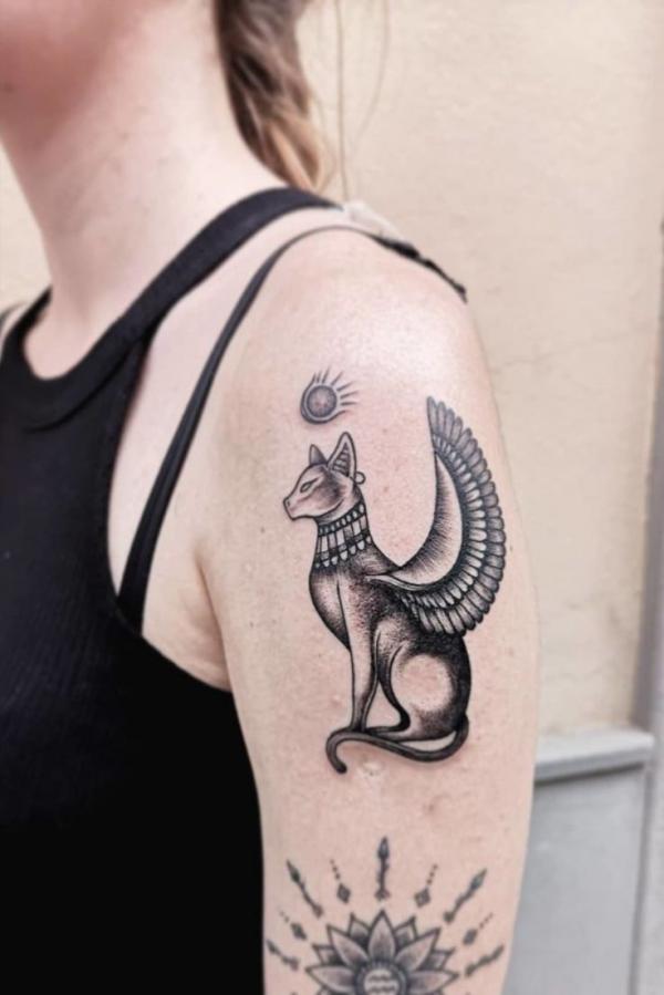 Small Bastet upper arm tattoo