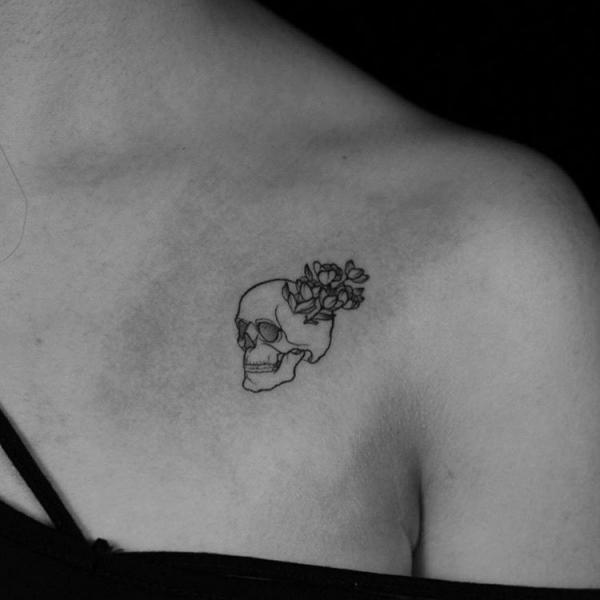 Small Skull outline with flowers tattoo
