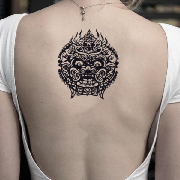 Small black and white foo dog back tattoo