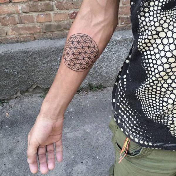 Small flower of life tattoo below elbow