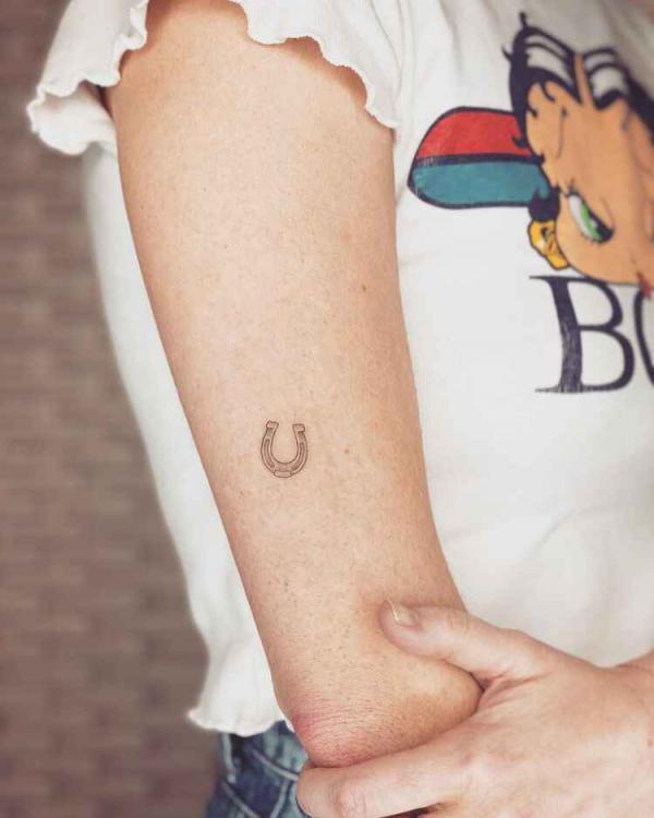 Small horseshoe back of arm tattoo
