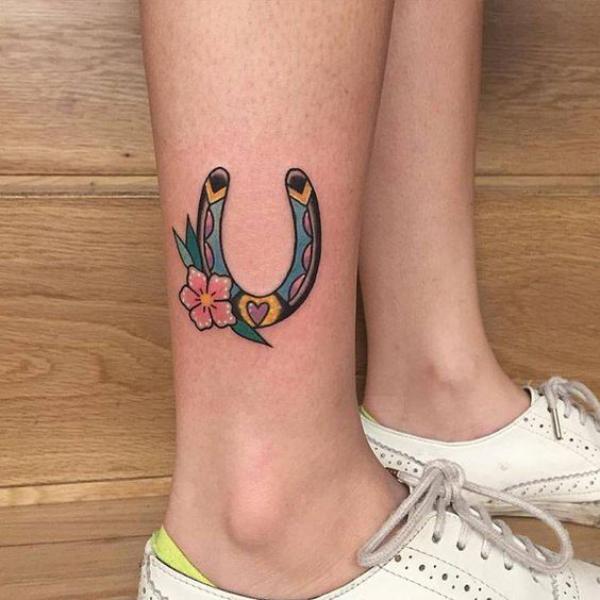 Small horseshoe tattoo above ankle