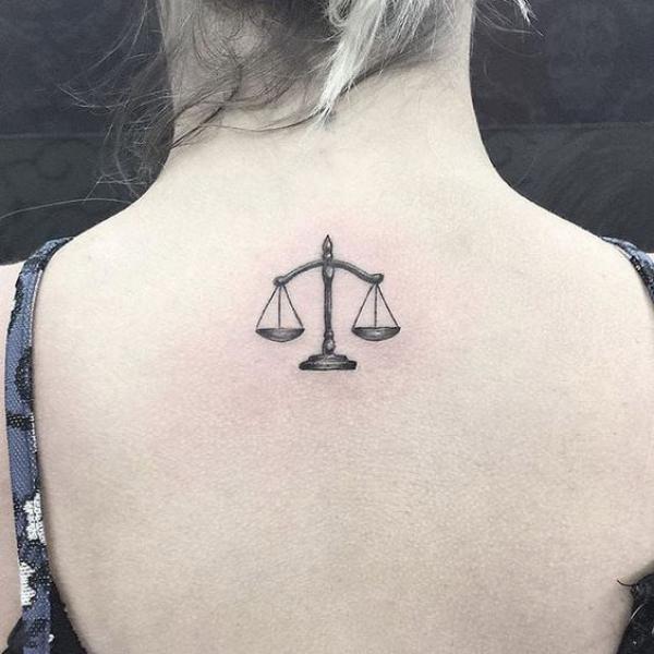 Small libra upper back tattoo