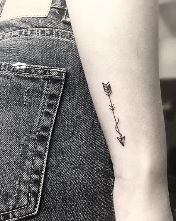 Small sagittarius arrow tattoo on forearm