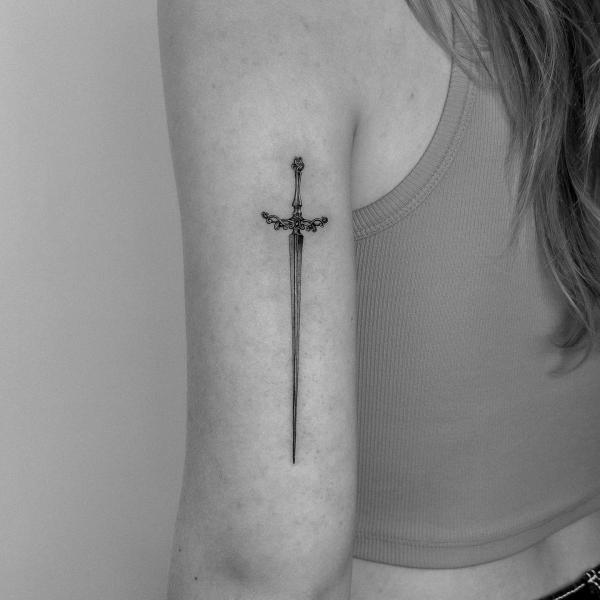 Small sword back of arm tattoo
