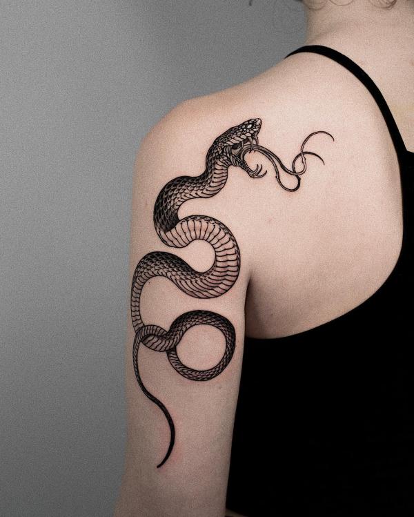 Snake back of arm tattoo