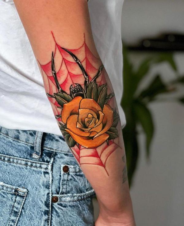 Spider and spiderweb with yellow rose tattoo on elbow