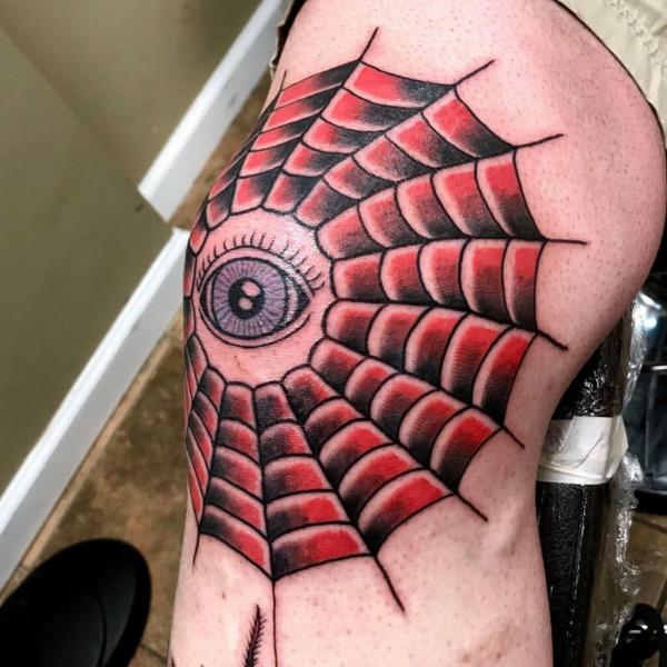 Spider web with eye tattoo on elbow
