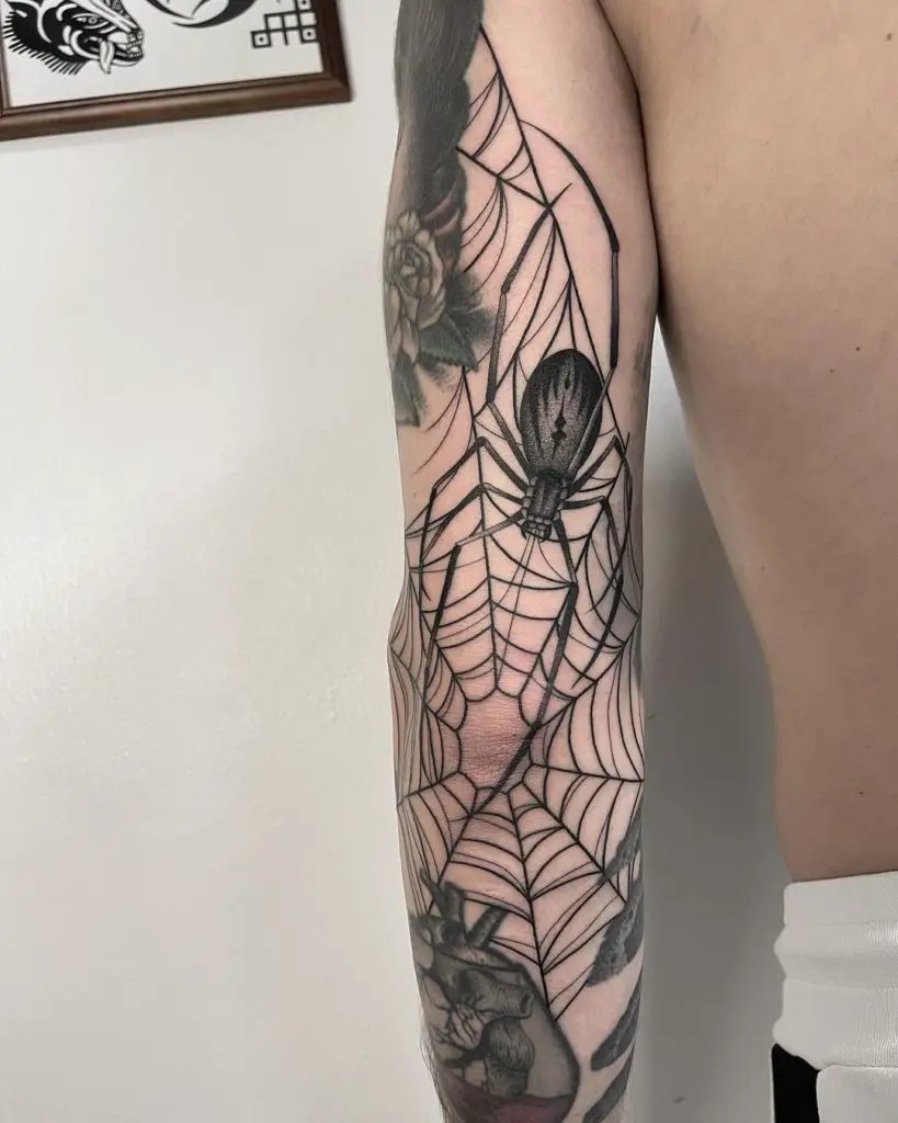 Spiderweb linework with spider elvow tattoo