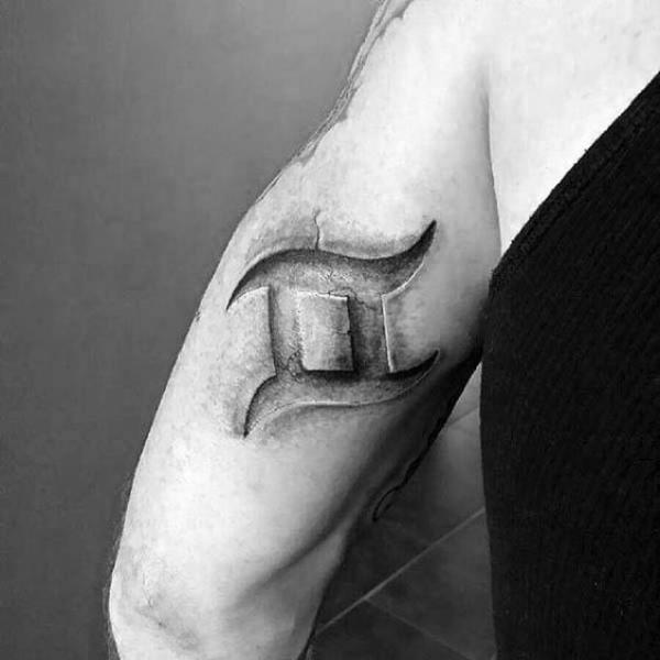Stone Gemini glyph back of arm tattoo