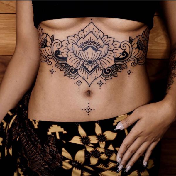 Stylized lotus sternum tattoo