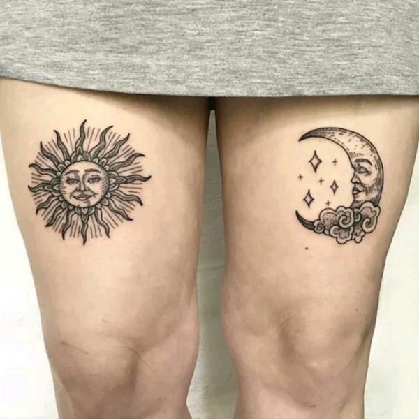 Sun and moon face tattoo above knee