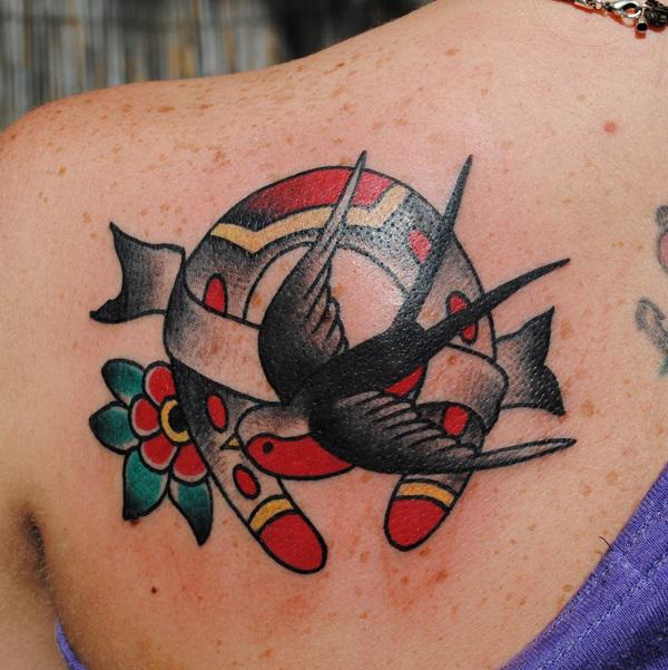 Swallow and horseshoe shoulder blade tattoo