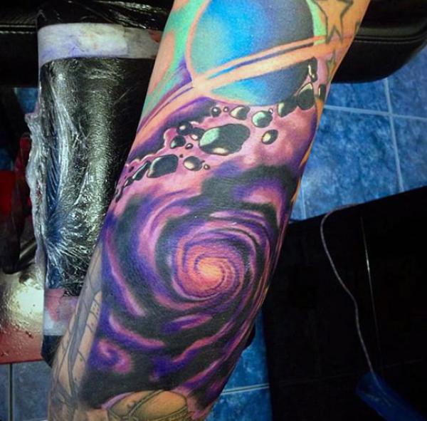 Swirling space elbow tattoo
