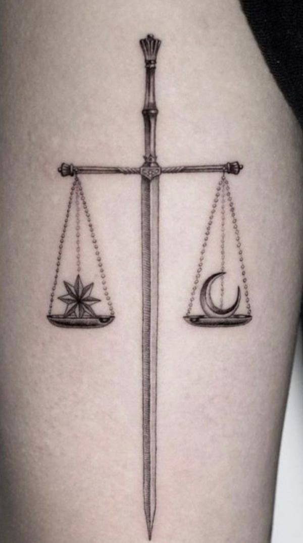 Sword libra with sun and moon tattoo