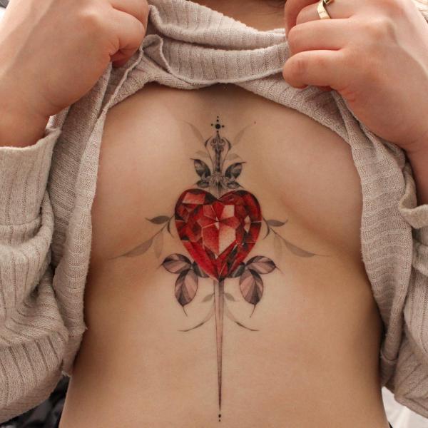 Sword with a heart shaped diamond sternum tattoo