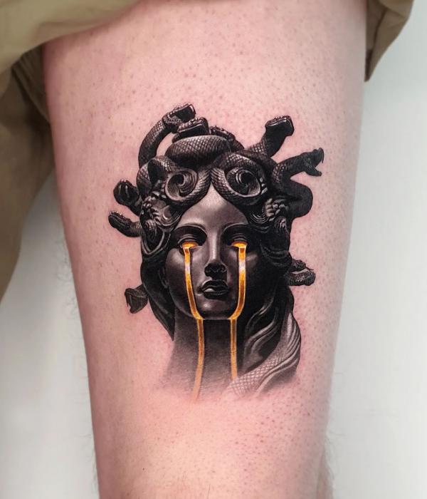 Tearing Medusa thigh tattoo