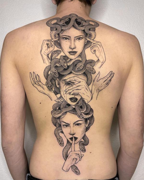 Three Medusa faces spine tattoo