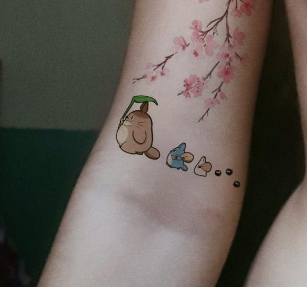 Three totoros walking with cherry blossom tattoo