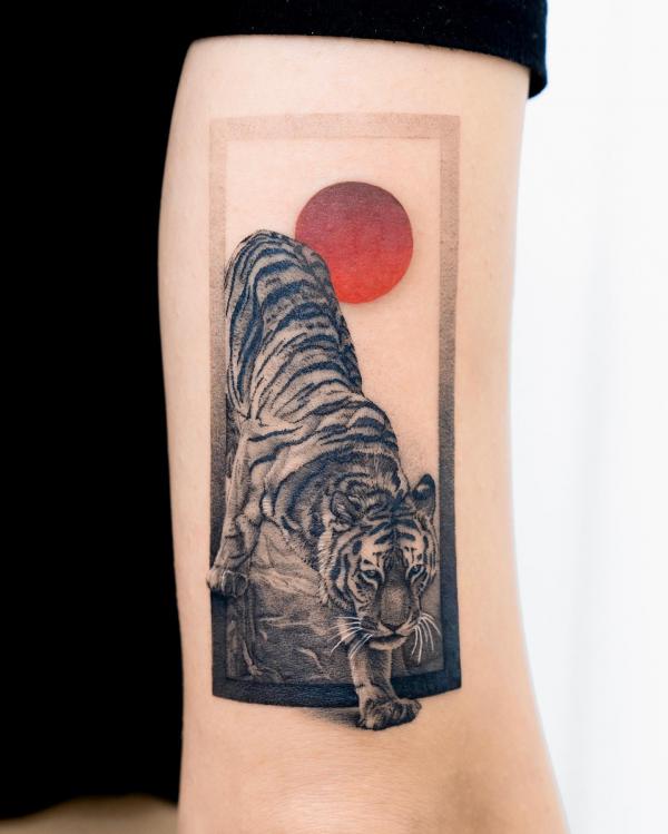 Tiger and sun rectangular back of arm tattoo