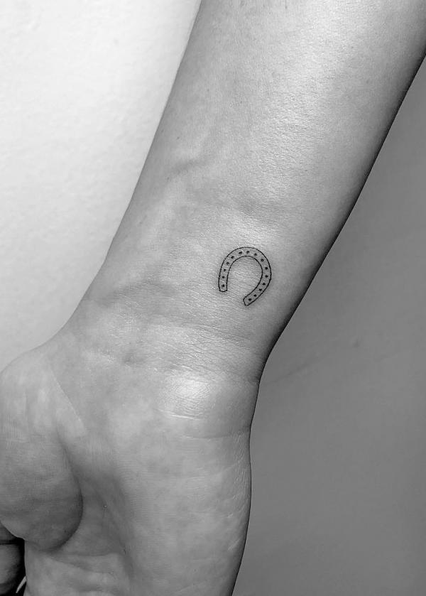 Tiny horseshoe wrist tattoo