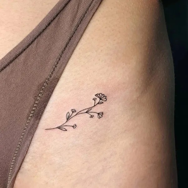 Tiny wild flower Bikini line tattoo