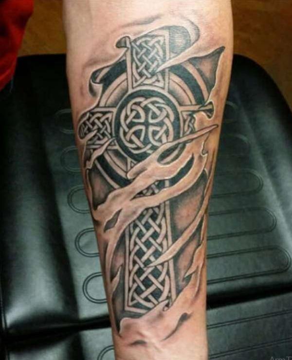 Torn skin Celtic cross arm tattoo