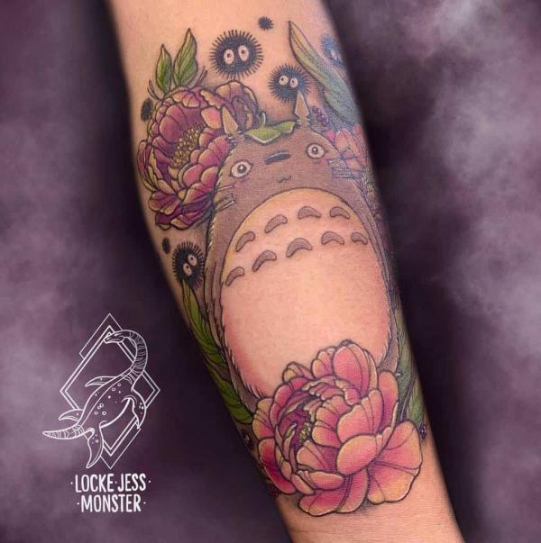 Totoro with peony tattoo on forearm