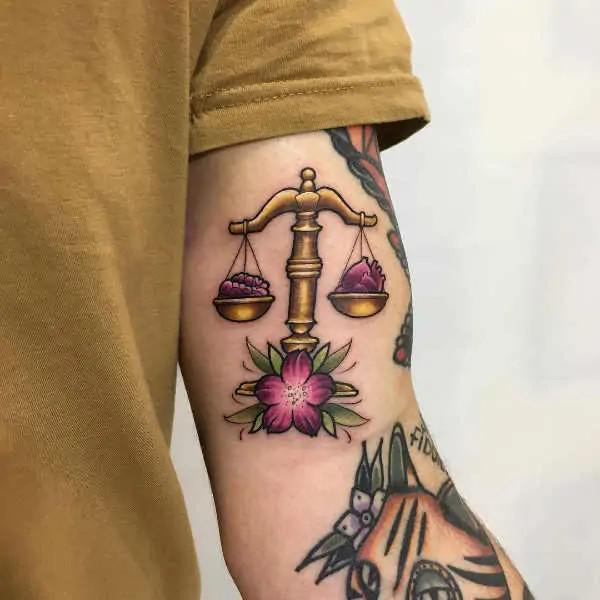 Traditional Libra with flower back of arm tattoo